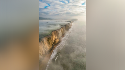 Winter mist rolling over cliffs has won the South West Coast Photographer of the Year 2025.