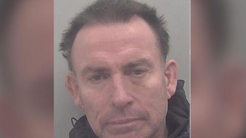 A police mugshot of David Buisson