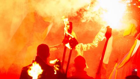 People holding torches with fire