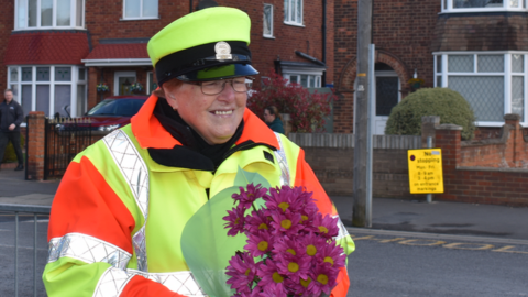 Beryl Quantrill holding a bouquet of flowers