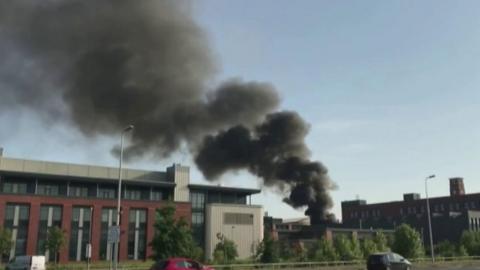 Thick black smoke above building