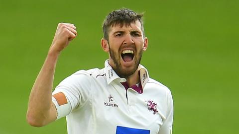 Craig Overton celebrates a wicket