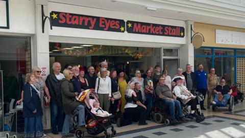 A large group of people outside Starry Eyes Performance Foundation new shop in Trowbridge's Castle Place shopping centre