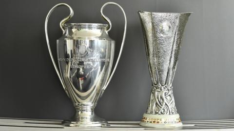 Champions League and Europa League trophies