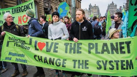 Protesters seen holding banners during the demonstration. Extinction Rebellion held a lock-down of Edinburgh's North Bridge as part of an international movement. Police Scotland made around 30 arrests over the course of the day as a result.