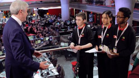 BBC Director General, Tony Hall, gets a grilling from school reporters Alex, Rima and Yusuf