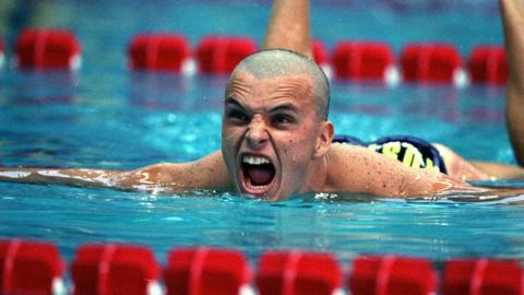 Scott Miller reacts after winning a silver medal in the mens 100m butterfly event at the 1996 Olympics in Atlanta