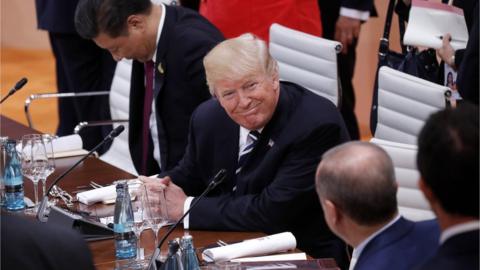 President Donald J. Trump (C) smiles towards Turkish President Recep Tayyip Erdogan (2-R, back to camera) while Chinese President Xi Jinping (L) takes his seat