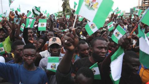 People waving Nigerian flags