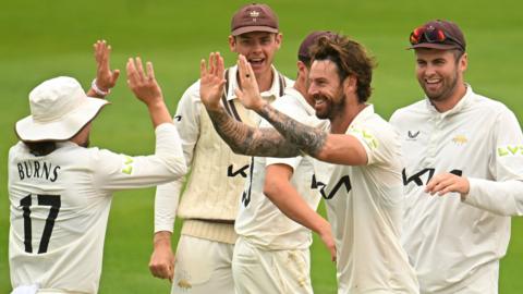 Jordan Clark takes a wicket for Surrey