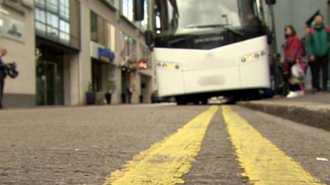 A coach parked on double yellow lines in Belfast