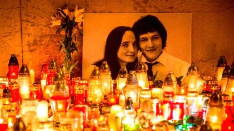 Hundreds of candles in front of a portrait of Slovak investigative journalist Jan Kuciak and his girlfriend Martina Kusnirova, who were murdered in 2018