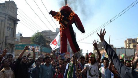 Protesters burning an effigy