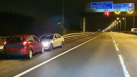 A car jump starting another on the M11