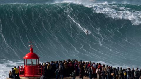 Rodrigo Koxa riding a wave in Nazare