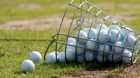 A bucket of golf balls