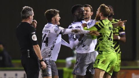 Players clash in the game between Forest Green Rovers and Colchester United