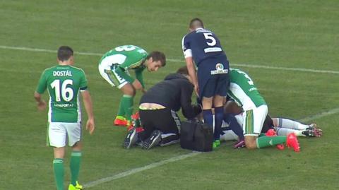 Injured player surrounded by other players