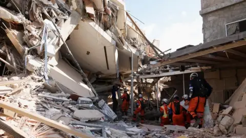 Rescue personnel from El Salvador assist in rescue efforts after earthquakes hit the country, in La Guaira, Venezuela