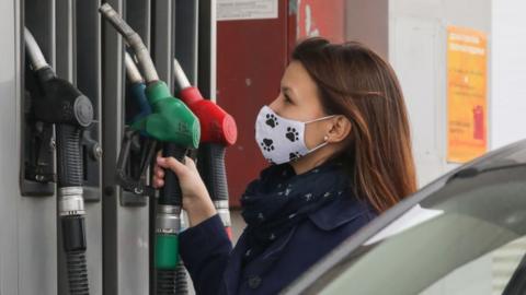 Woman at petrol pump