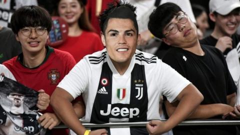 South Korean fans wear Ronaldo masks