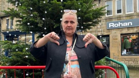 Joann Rotherer in front of Christmas tree