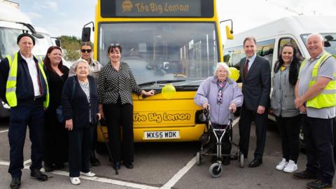 People standing in front of a mini bus run by The Big Lemon Group