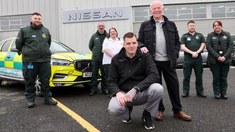 Frank with Nissan worker David Freeman and North East Ambulance Service staff at Nissan