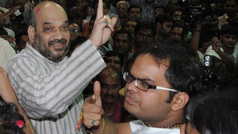 Indian politician and former Gujarat minister Amit Shah (L) and his son Jay celebrate on his arrival at his residence after his release from Sabarmati Central Jail in Ahmedabad late on October 29, 2010.