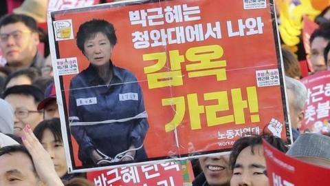 Anti-Park protesters in Seoul, 11 March. The sign reads Go to prison