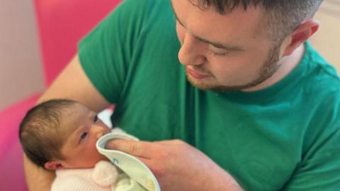 Ryan O’Connor holding his daughter Gia