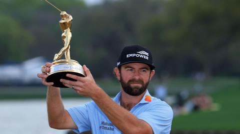 Cameron Young holds aloft the trophy after winning the Players Championship