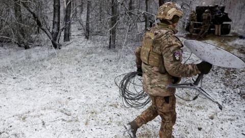 A Ukraine soldier with a Starlink unit