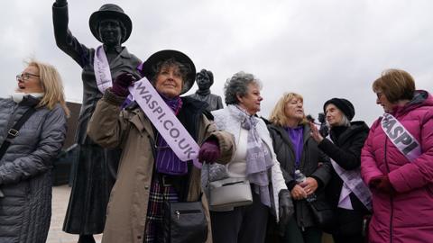 Campaigners for Women Against State Pension Inequality Campaign (Waspis) gather at the statue of political activist Mary Barbour in Glasgow in August 2023