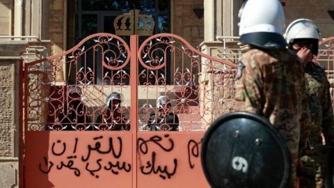 Iraqi security forces stand outside an entrance to the Swedish embassy in Baghdad, after protesters stormed the compound (29 June 2023)