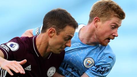 Jonny Evans battles with Manchester City's Kevin De Bruyne before having to go off because of injury