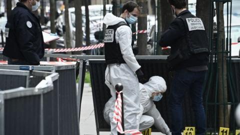 Police investigate the scene of a shooting outside a Paris hospital, 12 April 2021