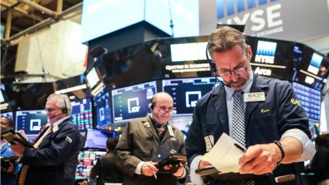 Traders work on the floor of the New York Stock Exchange (NYSE) in New York, U.S., December 28, 2018