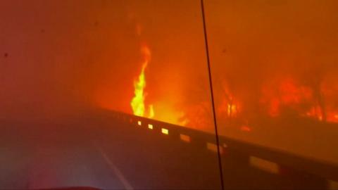 Flames raging along road in Texas wildfire