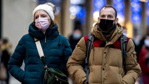 Couple walking in Cardiff in masks