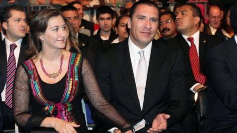 Martha Erika Alonso and Rafael Moreno Valle hold hands during an official ceremony in Puebla, Mexico. File photo