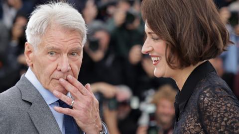 Harrison Ford and Phoebe Waller-Bridge attend the "Indiana Jones And The Dial Of Destiny" photocall at the 76th annual Cannes film festival at Palais des Festivals on May 19, 2023 in Cannes, France