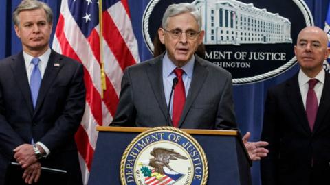 Attorney General Merrick Garland speaks alongside 鶹Լland Security Secretary Alejandro Mayorkas (L) and FBI Director Christopher Wray (R)