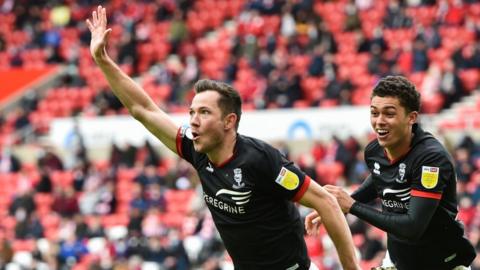 Tom Hopper leads the celebrations after scoring for Lincoln against Sunderland