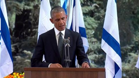 US President Barack Obama stands at the podium during Shimon Peres' funeral at Mount Herzl, Israel's national cemetery