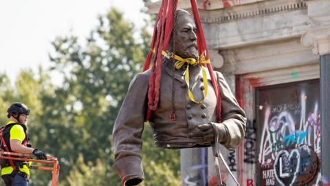 A confederate statue of Robert E Lee removed in Richmond, Virginia.