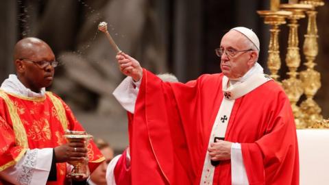 Pope Francis sprinkles holy water during a Mass of Pentecost at Saint Peter"s Basilica at the Vatican, May 20, 2018.