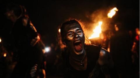 Participant with fire in background