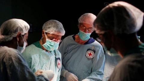 British vascular surgeon John Wolfe, who was invited to Gaza by the International Committee of the Red Cross (ICRC), performs a surgery for a wounded Palestinian in the operating room in a hospital in Gaza City April 25, 2018
