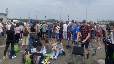 People waiting for luggage outside the airport